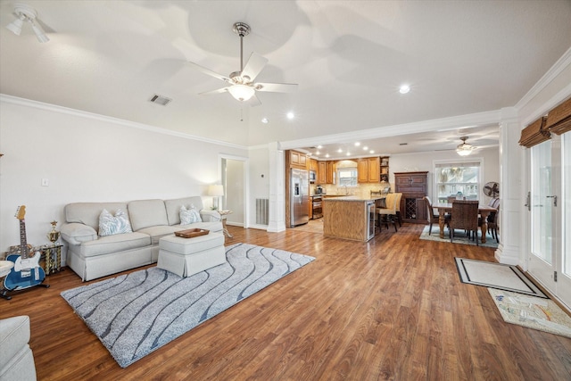 living room featuring light hardwood / wood-style floors and ornamental molding