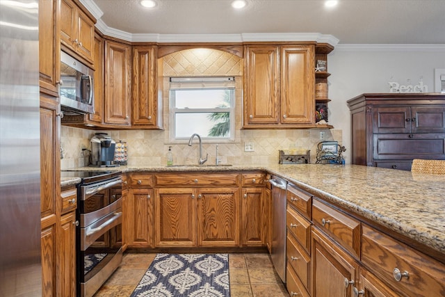 kitchen with crown molding, sink, light stone countertops, appliances with stainless steel finishes, and tasteful backsplash