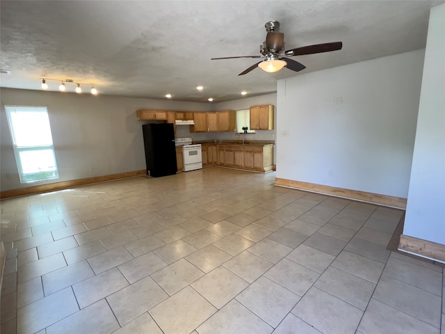 unfurnished living room with light tile patterned floors, a textured ceiling, ceiling fan, and sink