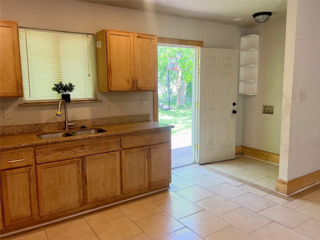 kitchen featuring light tile patterned flooring and sink