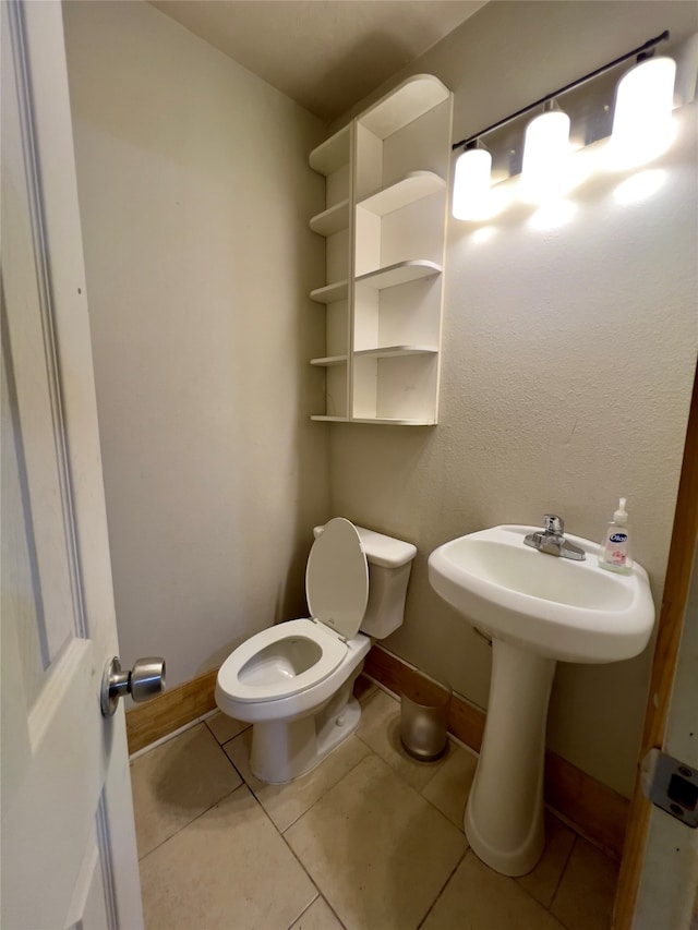 bathroom featuring tile patterned flooring and toilet