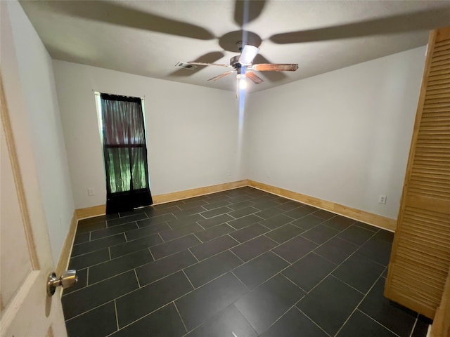 tiled empty room with ceiling fan