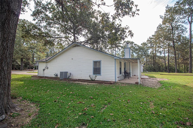 view of home's exterior with a patio area, a lawn, a chimney, and central air condition unit