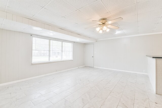 unfurnished room featuring a paneled ceiling and ceiling fan