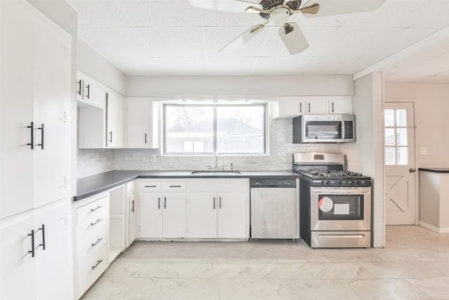 kitchen with white cabinets, backsplash, stainless steel appliances, and sink