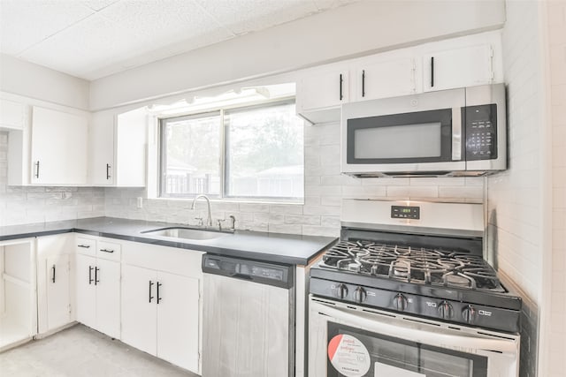 kitchen with appliances with stainless steel finishes, tasteful backsplash, white cabinetry, and sink