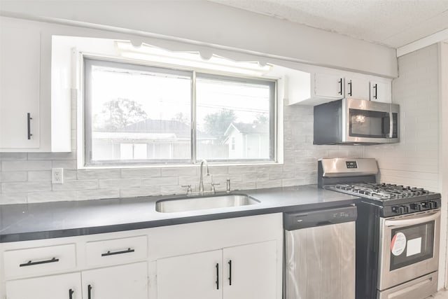 kitchen featuring tasteful backsplash, white cabinetry, sink, and stainless steel appliances