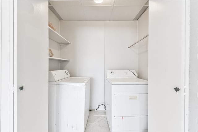 laundry room with light tile patterned floors and washer and dryer