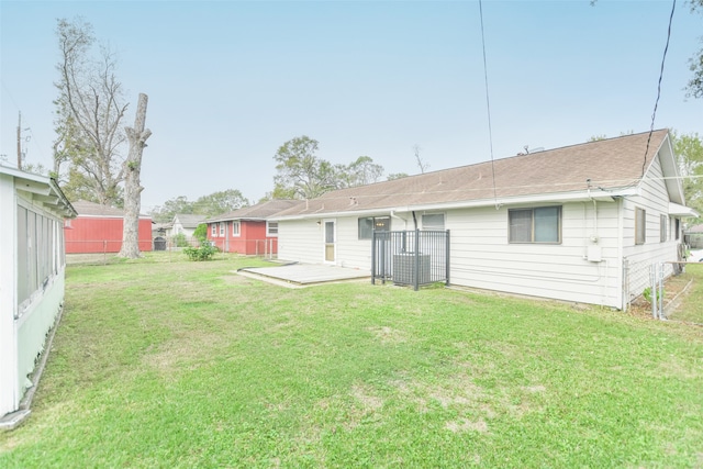 back of house featuring a yard and a deck