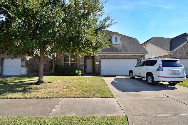 view of front of property with a garage and a front lawn