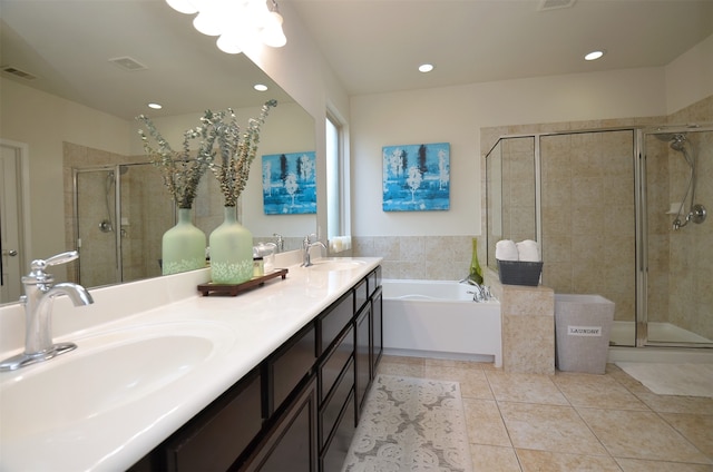 bathroom featuring plus walk in shower, tile patterned flooring, and vanity