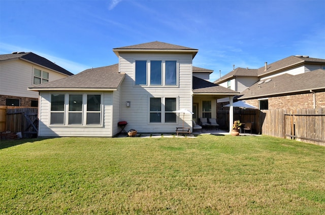 back of property featuring a yard and a patio