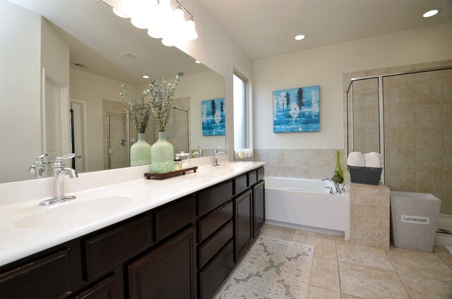 bathroom with plus walk in shower, vanity, and tile patterned floors