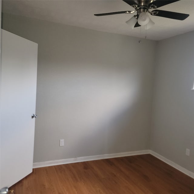 spare room featuring ceiling fan and dark wood-type flooring