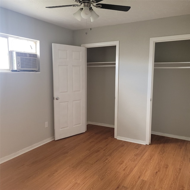 unfurnished bedroom featuring ceiling fan, cooling unit, and light hardwood / wood-style floors