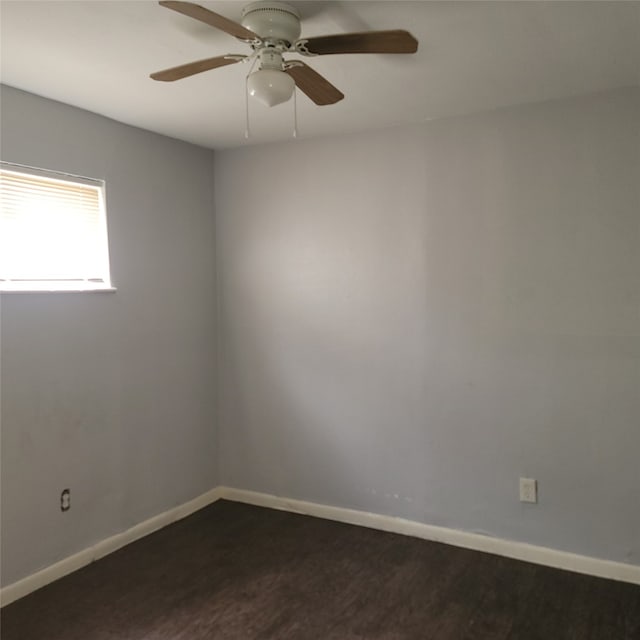 empty room with dark hardwood / wood-style floors and ceiling fan