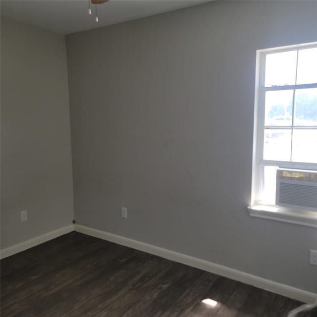 empty room with dark hardwood / wood-style floors, cooling unit, and ceiling fan