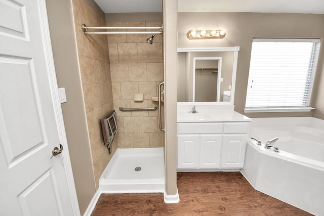 bathroom featuring wood-type flooring, vanity, and independent shower and bath