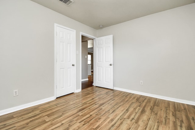 unfurnished bedroom with light wood-type flooring