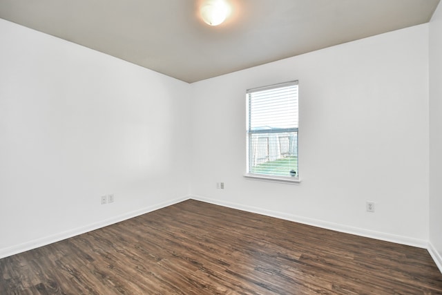 spare room with dark wood-type flooring