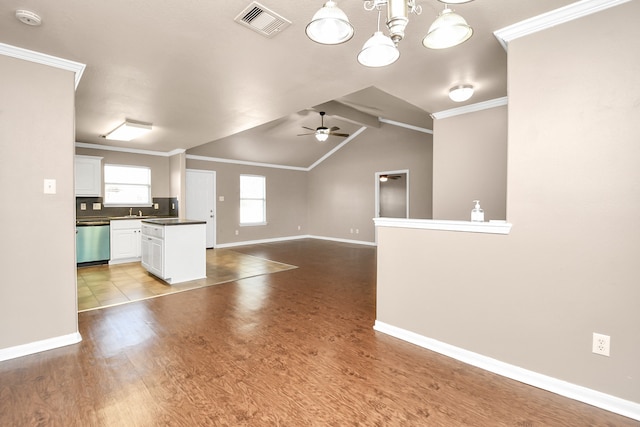 unfurnished living room with crown molding, lofted ceiling with beams, ceiling fan with notable chandelier, and wood-type flooring