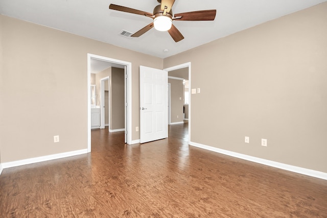 unfurnished room with dark hardwood / wood-style floors and ceiling fan