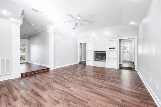 unfurnished living room featuring vaulted ceiling, dark hardwood / wood-style flooring, plenty of natural light, and ornamental molding