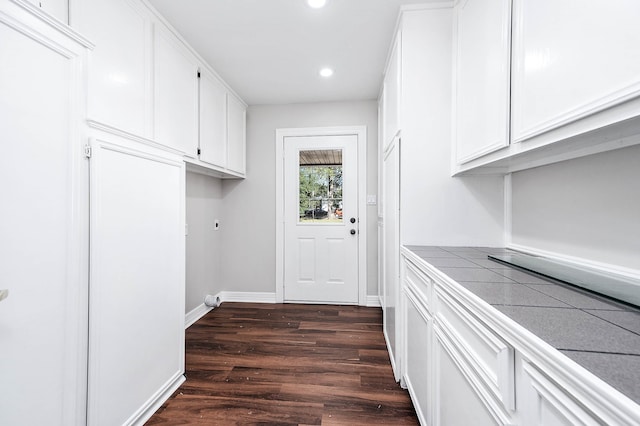 laundry room featuring cabinets, dark hardwood / wood-style floors, and hookup for an electric dryer