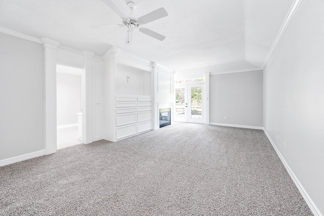 unfurnished living room with carpet flooring, ceiling fan, ornamental molding, and french doors