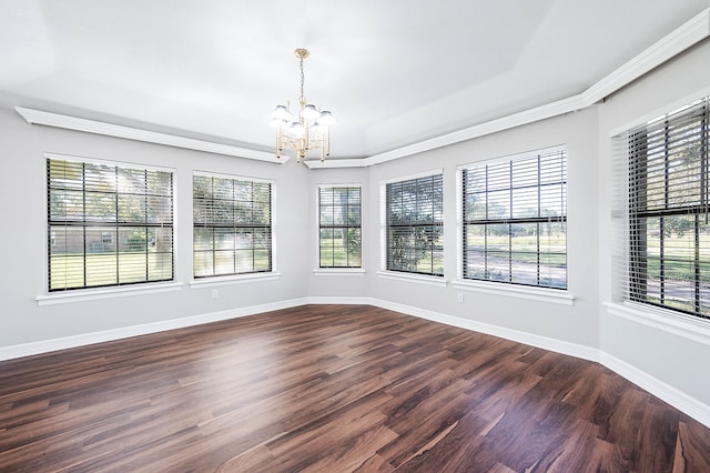 unfurnished room featuring crown molding, dark wood-type flooring, and a notable chandelier