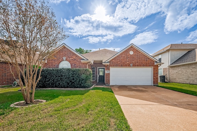 view of front of home with a garage, central AC unit, and a front yard