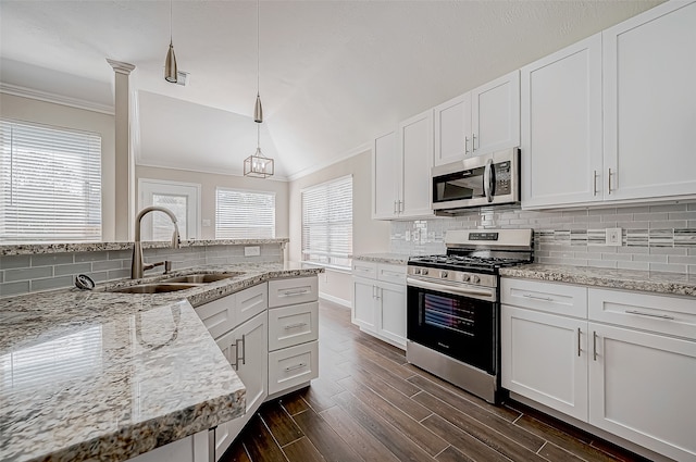 kitchen with pendant lighting, white cabinetry, sink, and stainless steel appliances