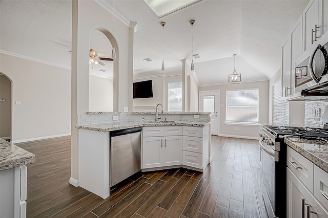 kitchen featuring lofted ceiling, white cabinets, ceiling fan with notable chandelier, sink, and stainless steel appliances