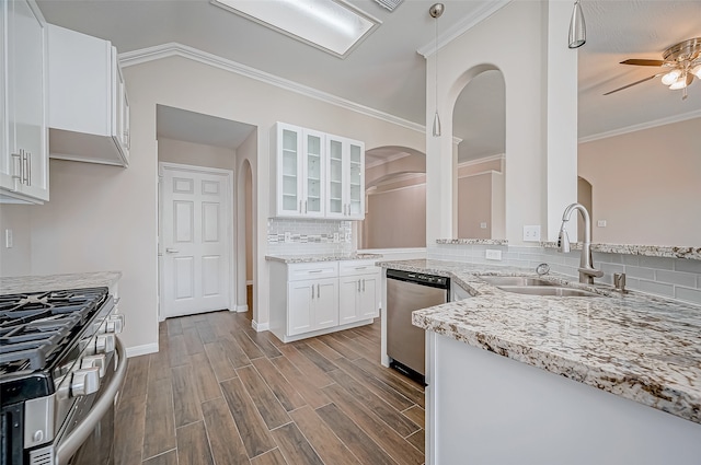 kitchen featuring backsplash, sink, light hardwood / wood-style floors, white cabinetry, and stainless steel appliances