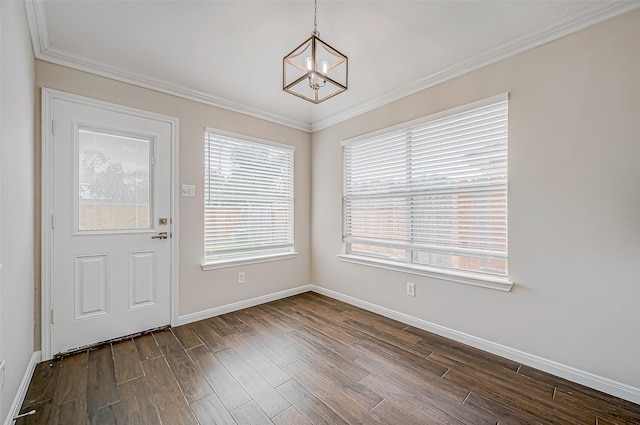 interior space with hardwood / wood-style floors, ornamental molding, and a notable chandelier