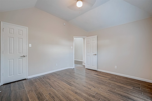 empty room with ceiling fan, wood-type flooring, and vaulted ceiling