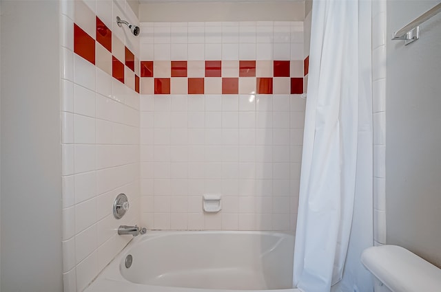 bathroom featuring shower / bath combo and toilet