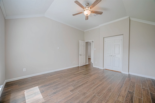 unfurnished bedroom with ceiling fan, ornamental molding, vaulted ceiling, and light wood-type flooring