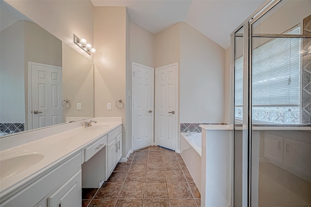 bathroom with tile patterned flooring, vanity, separate shower and tub, and lofted ceiling