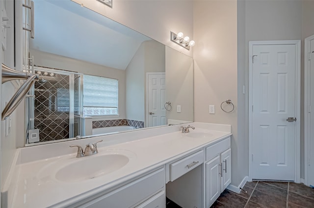 bathroom featuring plus walk in shower, vanity, tile patterned floors, and lofted ceiling