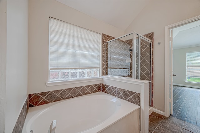 bathroom with independent shower and bath, vaulted ceiling, and wood-type flooring