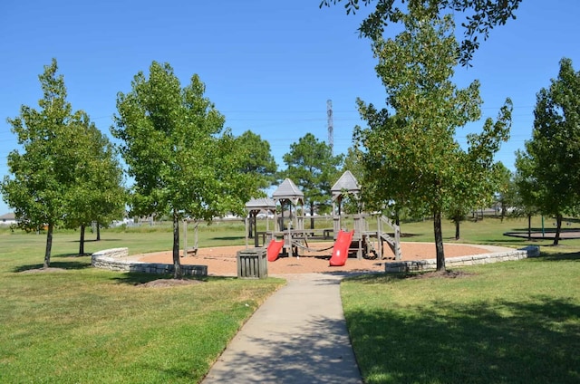 view of property's community featuring a lawn and a playground