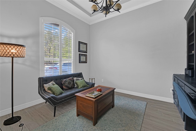 living room featuring wood-type flooring, crown molding, and a chandelier