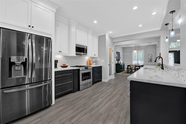 kitchen featuring white cabinetry, stainless steel appliances, and light hardwood / wood-style floors