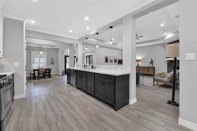 kitchen featuring ceiling fan, light stone countertops, stainless steel appliances, light hardwood / wood-style floors, and decorative light fixtures