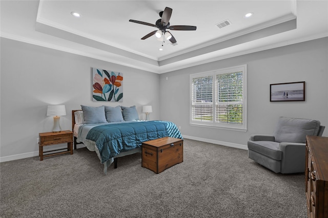 bedroom with a raised ceiling, ceiling fan, crown molding, and carpet floors