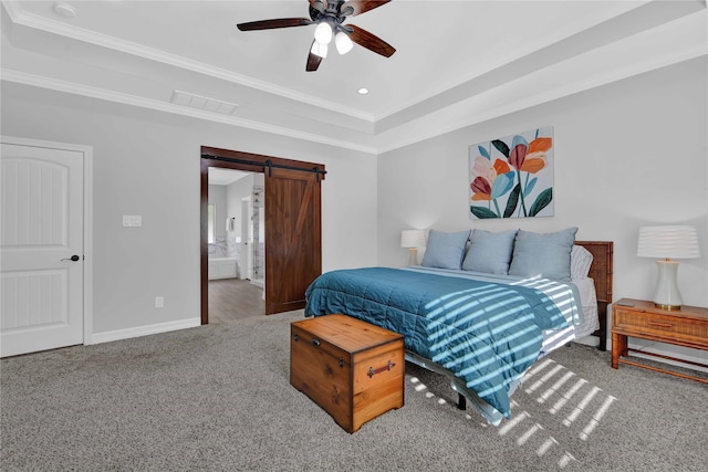 carpeted bedroom featuring ceiling fan, a barn door, crown molding, and ensuite bath