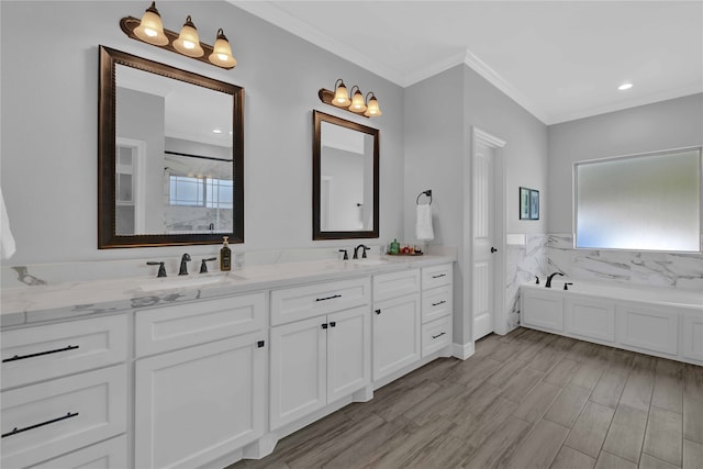 bathroom with a washtub, hardwood / wood-style floors, and a healthy amount of sunlight