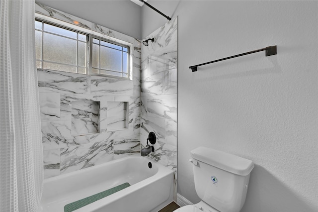 bathroom featuring toilet and shower / bathtub combination with curtain