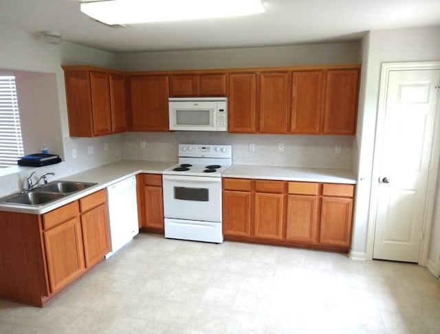 kitchen featuring decorative backsplash, sink, and white appliances